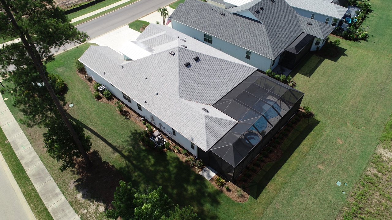 Real Estate Photography - Drone Photo over Home for Sale with Pool